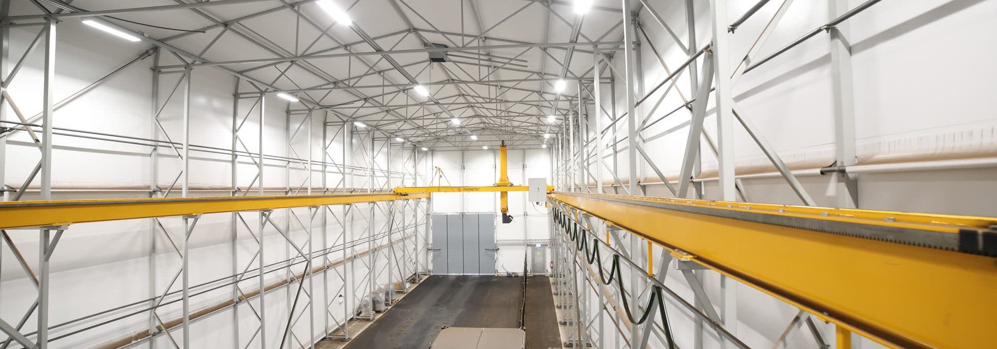 Automated biomass fuel sampling facility equipped with bridge crane sampling systems and sample handling infrastructure.