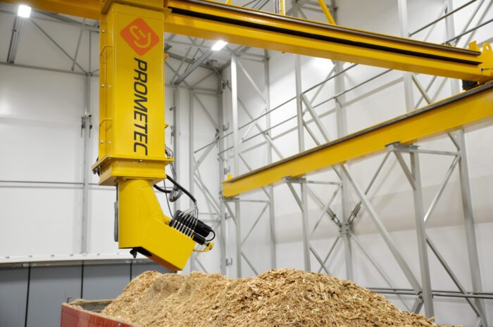 Automated drill sampler collecting a representative wood chip sample for biomass fuel quality analysis.