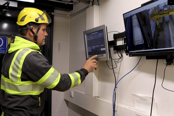 A truck driver starting Q-robot sampler from the touch screen
